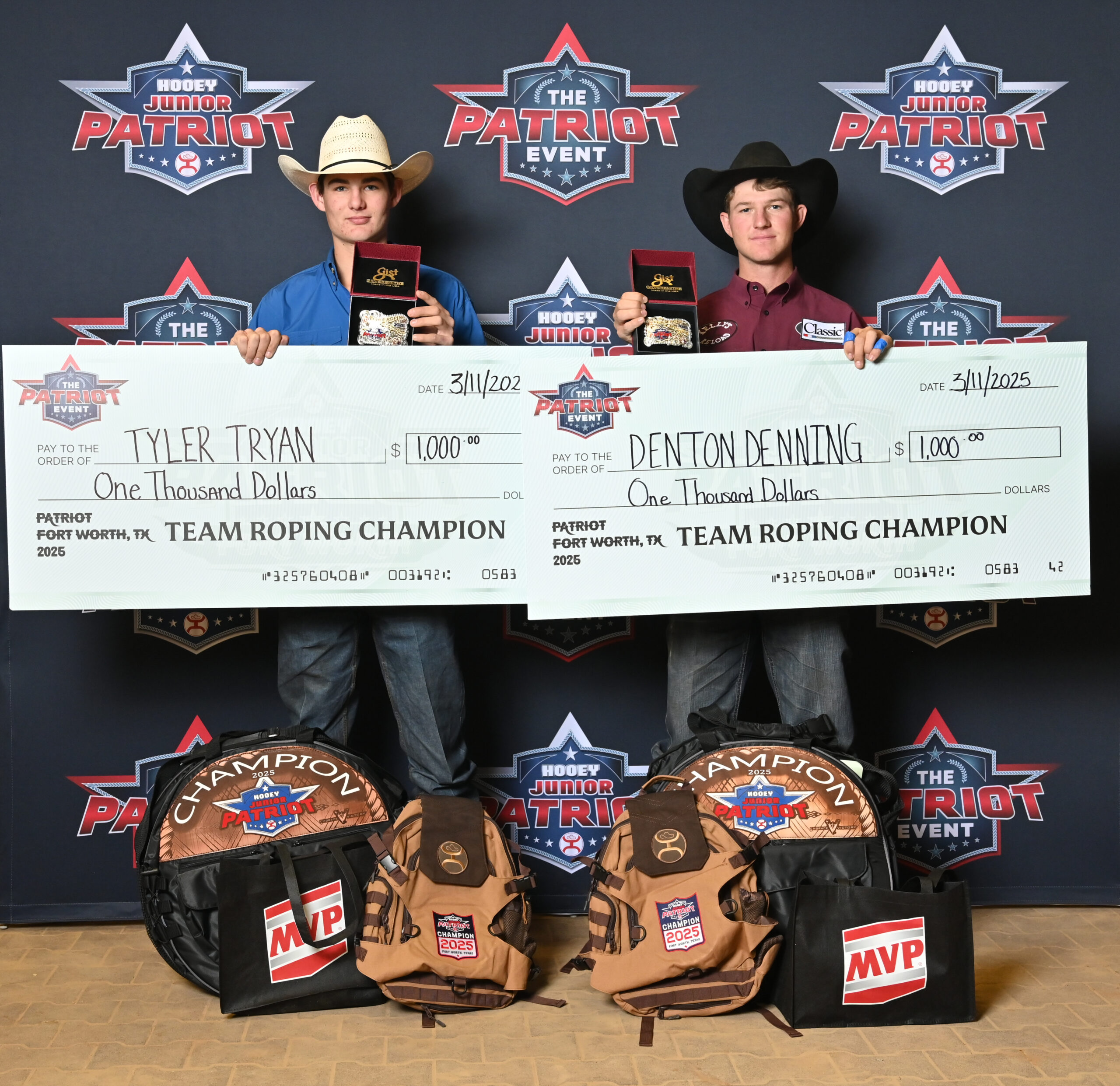 Two young rodeo competitors hold $1,000 championship checks and MVP backpacks at the Hooey Junior Patriot Event team roping competition in Fort Worth, Texas